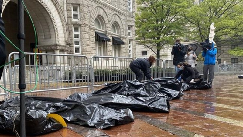 Protesters dump body bags outside Trump Hotel to condemn his COVID response